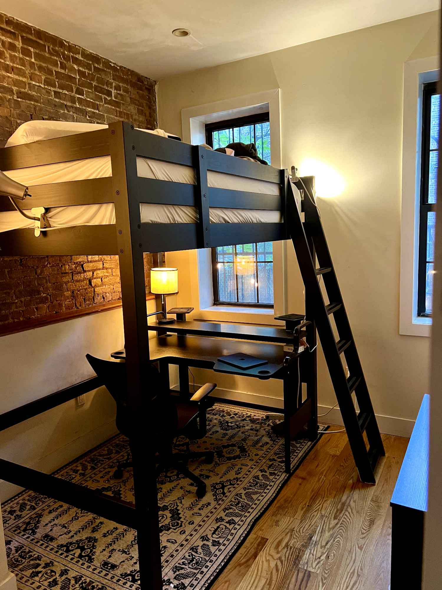 I'm leaving town until December and need someone to take my room! Move-ins as soon as the 15th and as late as the 1st will be accepted. No option to extend--this is hands down the best place I've lived since moving to NYC and I will definitely be coming back. But I'd be happy to have the room occupied in the meantime, and share such a great spot with someone cool.
The room is FULLY FURNISHED, with a lofted bed and full-sized memory foam mattress, a chest of drawers, a nice desk, and my speaker towers if you'd like to set up an audio system. It's on the smaller side, but made much more spacious thanks to the loft bed and a decently-sized closet. You'll be getting a surprising amount of sunlight, especially in the mornings, and the view right now is very nice and very green.
The apartment itself is even better than the room--it's a 4-bed with three (male) roommates, but I've never once felt crowded; the guys are chill and open-minded, and we've got 2.5 bathrooms between us, spread across two whole floors: the ground floor, and a private basement level with private backyard access. One room in the basement has been converted to a rehearsal space for musicians, since a lot of us here make music. Someone creative will feel right at home, but either way the rehearsal space is used respectfully with regards to those of us upstairs; if you need silence, you'll get it. The apartment also comes with a dishwasher and easy laundry access through the basement, both of which I've been very much appreciating.
Since I'll be off the grid, part of this process may be conducted by my roommates, and payment will be handled through Zelle exclusively. A background check will be conducted beforehand, but barring anything serious I don't intend on rejecting people if I can help it. Mostly I just want someone who seems like a good fit, who'll appreciate the space, and who'll get along well with my roommates.