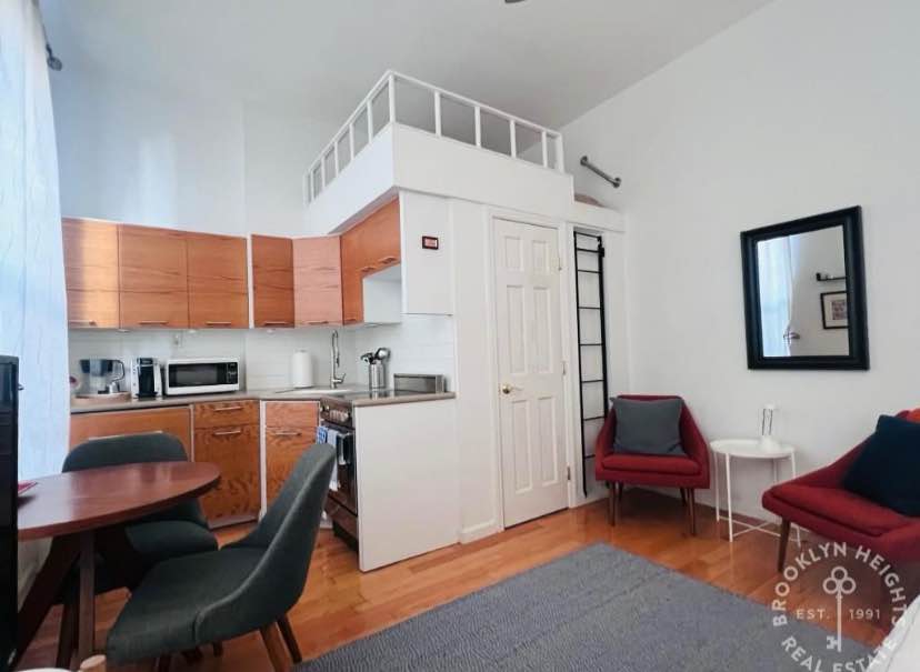 This charming parlor-floor studio, featuring high ceilings and a full renovation, is ideally located in the heart of Cobble Hill! Available furnished or unfurnished, the apartment boasts hardwood floors throughout, a beautifully updated kitchen and bathroom, and excellent closet space. The lofted area offers versatile use as either a sleeping loft or extra storage. Other highlights include 10-foot ceilings and three large south-facing windows that flood the space with natural light.