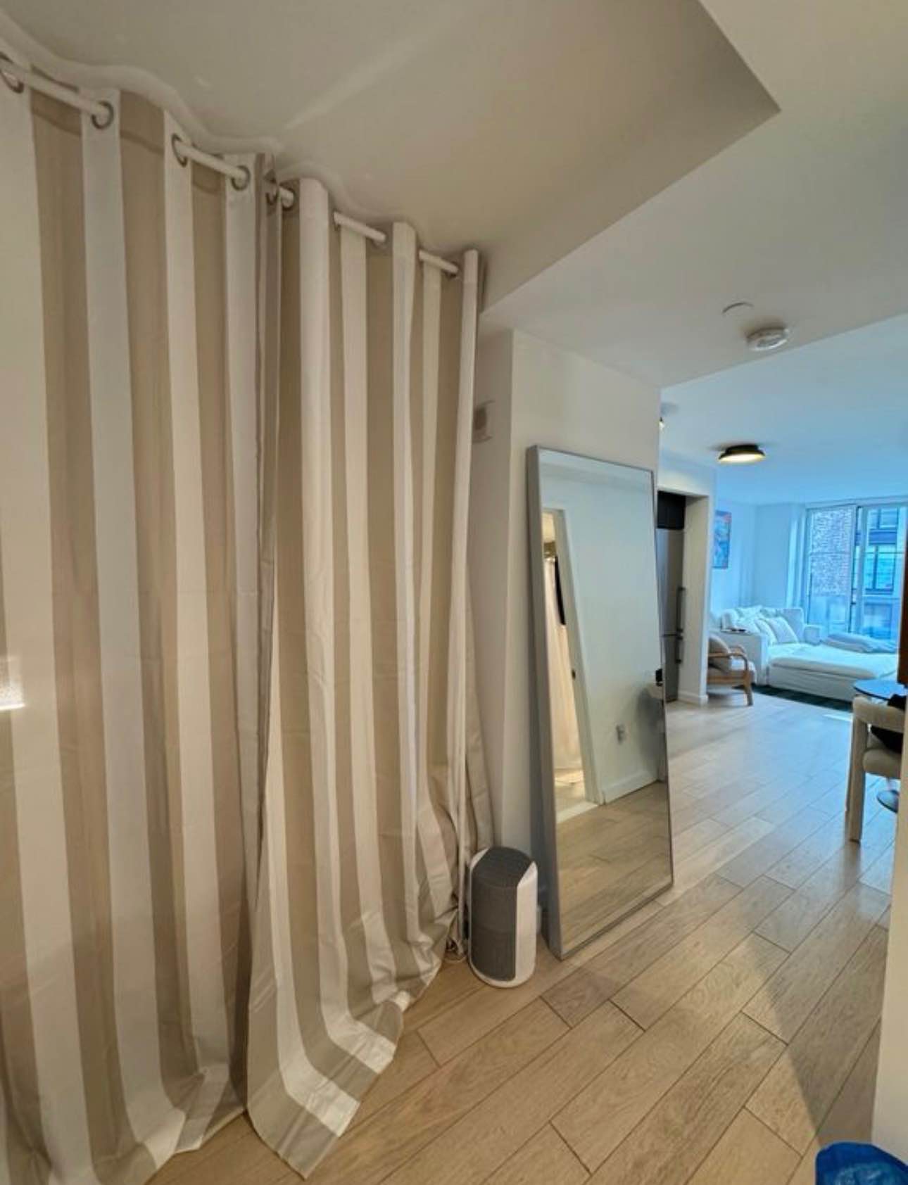 I'm looking for a chill, responsible candidate to lease my beautiful and bright apartment. This place is basically brand new and has a clean, modern luxury feel. The whole apartment features gorgeous light wood floors and huge windows that let in tons of light.

The common area is open-concept and perfect for relaxing: we have a big, comfy sectional couch, a stylish TV console, and a nice dining area. The kitchen is a standout with sleek black and white cabinets, subway tile backsplash, and full stainless steel appliances, including a dishwasher and gas range.

The available room is a large alcove space that is beautifully defined by floor-to-ceiling curtains for privacy, it easily fits a queen bed and has a built-in closet. You get the feel of a full bedroom but with great access to the rest of the apartment.

I keep the place very clean and tidy and I’m looking for someone who does the same. If you're looking for a high-quality living situation in a great location, send me a message and tell me a bit about yourself!