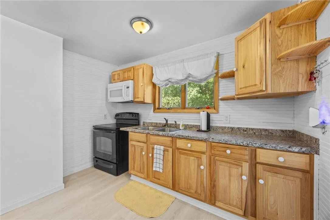 spacious Village Cape Cod style home featuring updated kitchen, bathroom and flooring. Additional interior highlights include ample bedrooms, first floor laundry room, lots of room for storage, 